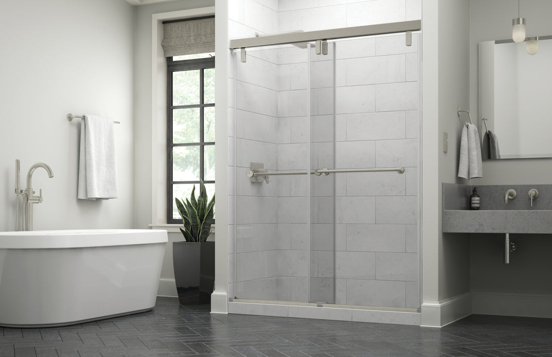 Sliding shower door and bathtub shown in bathroom